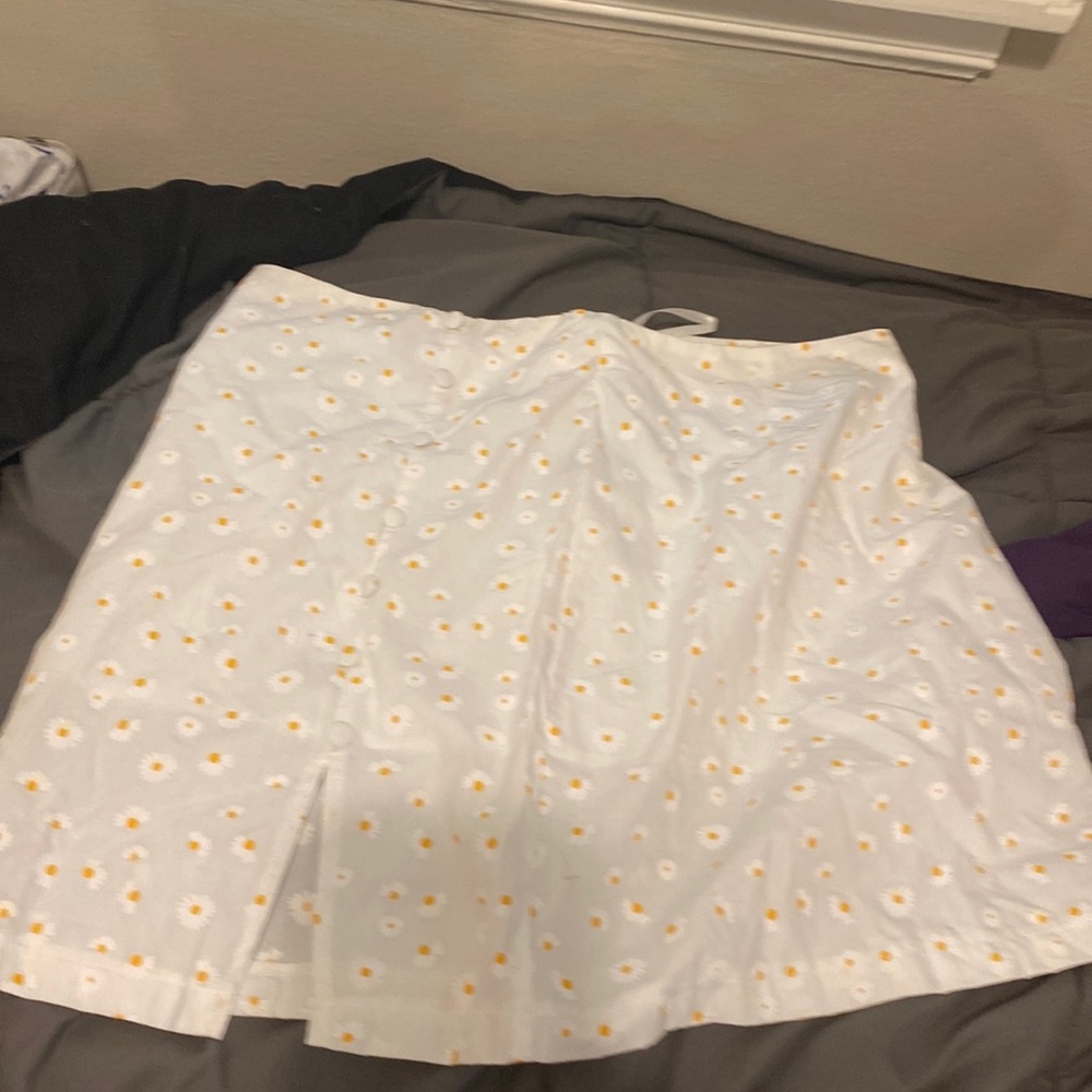 White skirt with buttons on side and yellow flowers